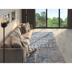 Útulná obývačka s béžovou pohovkou, hnedými závesmi výborne dopĺňa šedo modrý chlpatý koberec s vintage nádychom.
